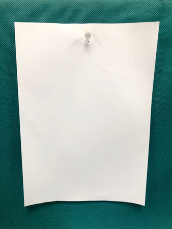 A4 paper spiked by pushpin in a boardの写真素材