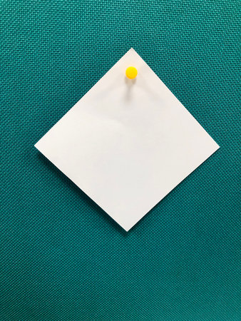 Square paper spiked by pushpin in a boardの写真素材