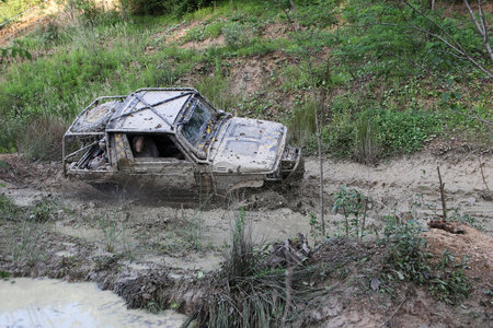 Offroad race - 4x4 car driving through mudの写真素材