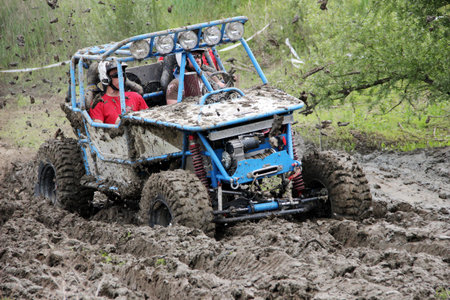Offroad race - 4x4 car driving through mudのeditorial素材