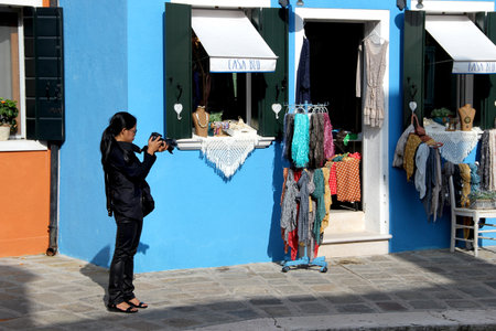 Female photographer is examining photos on DSLR cameraのeditorial素材