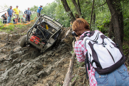 Woman Photographer is taking Picture of 4wd off-road vehicleのeditorial素材