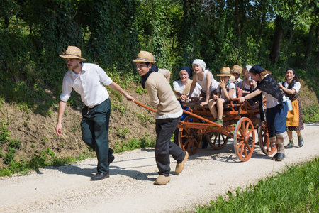 Boys pulled an old farm wagon with group of children.のeditorial素材