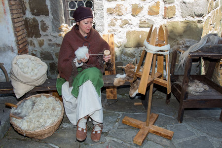 Medieval craftsman with Raw Sheep Wool in vintage clothes on on historical reenactment in Gorizia, Italy.のeditorial素材