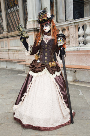 Female Venetian Mask with gun on St. Mark's Square in Veniceの写真素材