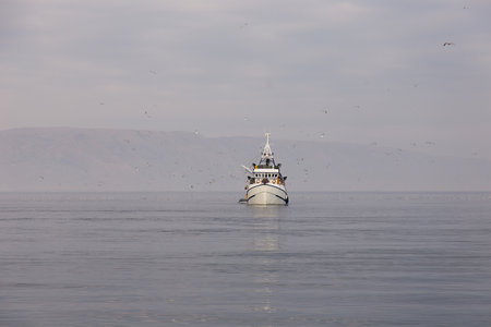 Fishing boat on the sea - fisherman return to harbor with night catch fishの写真素材