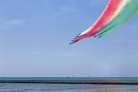 ecce Tricolori (Tricolour Arrows) - Airshow exhibition over Grado beach, Italyのeditorial素材