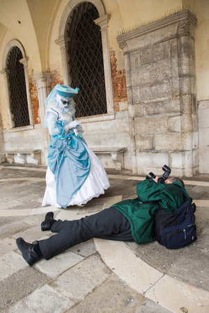 Venice Carnival - Photographer taking pictures of Venetian mask on St. Mark's Square in Venice.のeditorial素材