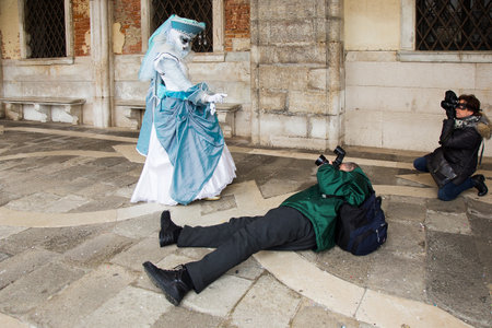 Photographer taking pictures of Venetian mask on St. Mark's Square in Venice, Venice Carnival, Italy.のeditorial素材
