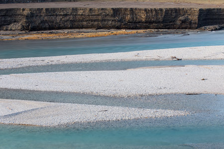 Diagonal line of river coast with low level of water, Empty accumulation lake, Most na Soci, Slovenia, water backgroundの写真素材