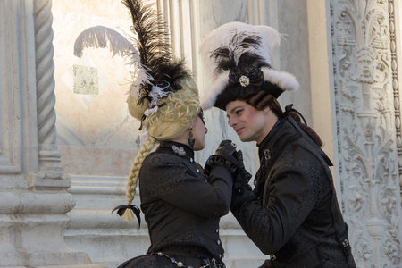 Lovely Couple of Venetian masks in elegant black costume on San Zaccaria Square, Venice Carnival, Italyのeditorial素材