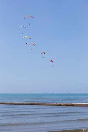 Airshow exibition of multicolored powered parachutes, Grado beach, Italy.のeditorial素材