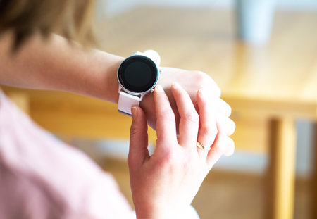 Hands of woman wearing smart watch. Technology and business concept. Modern lifestyle.の写真素材