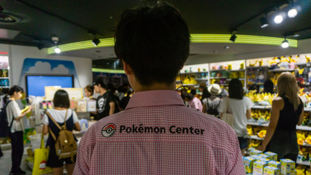 Tokyo, Japan - August 2018: Unidentified Pokemon Center sales person with Pokemon shirt in Pokemon Centerのeditorial素材