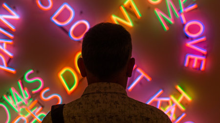 San Francisco, USA - August 2019: Man looking at colorful neon signs in San Francisco Museum of Modern Artsのeditorial素材