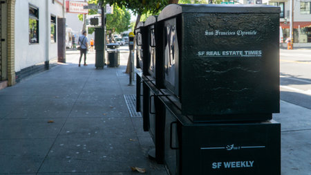 San Francisco, USA - August 2019: SF Chronicles newspaper vending machines on a sidewalk