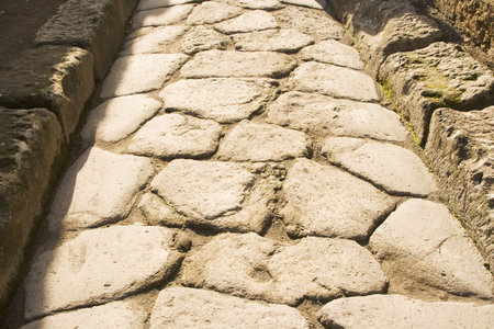 Close up of excavated cobblestone street in the city of Pompeii.  Buried by Mt. Vesuvius eruption in 79 AD.の写真素材