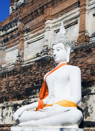Buddha statue at ruins of the Buddhist temple Wat Yai Chai Mongkol in Ayutthaya near Bangkok,...