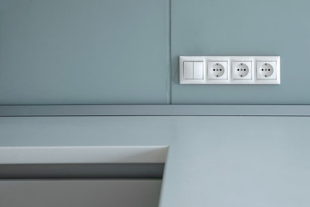 three electrical sockets with a switch on the wallの写真素材