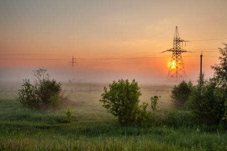 Wire electrical energy landscape at sunrise in the field