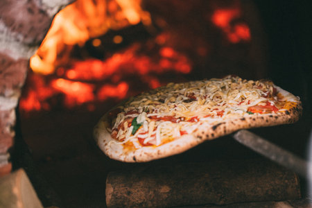 tasty pizza out of oven in restaurant kitchenの写真素材