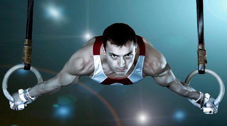 The sportsman the guy, carries out difficult exercise, sports gymnastics