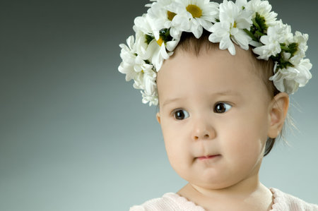 very beautiful  little kid with diadem of flowers, stare , very closeup faceの写真素材