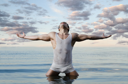 the very muscular handsome sexy guy on sky and sea backgroundの写真素材