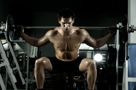 very power athletic guy ,  execute exercise with  dumbbells, in  sport-hallの写真素材