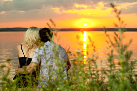 horizontal photo the  happy  couple, outdoor on beauty sunset or sunrise, on beachの写真素材