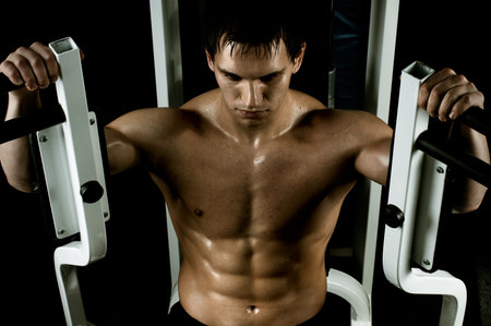 very power athletic guy ,  execute exercise with  weight, in  sport-hall, beauty glamour light