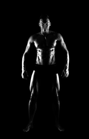 the very muscular handsome sexy guy on black background, full-length,  black-and-whiteの写真素材