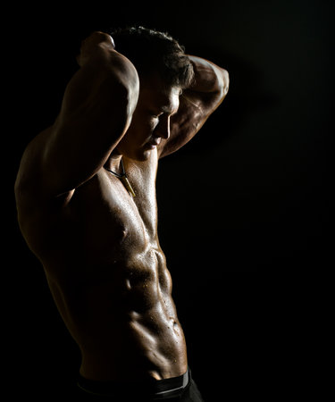 the very muscular handsome sexy guy on black の写真素材