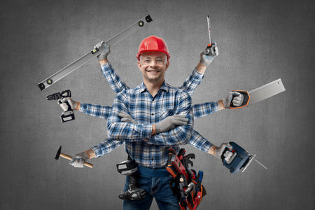 happy worker handyman (Jack of all trades) or builder with construction tools, stand and smile, on...