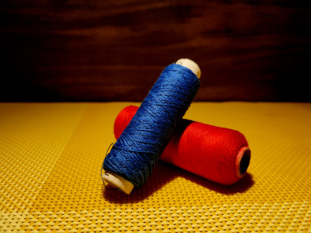 Multicolor sewing threads with dark background.