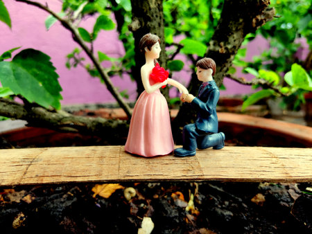 Innovative showpiece image of cute boy and girl on flower pot.の写真素材