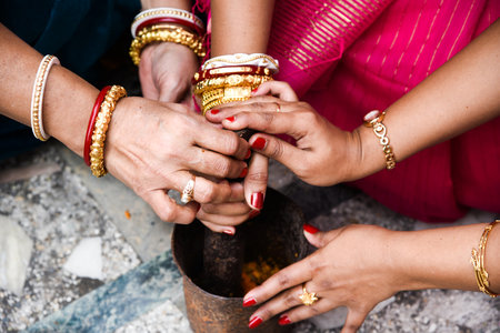 Women are performing indian bengali wedding rituals.の写真素材