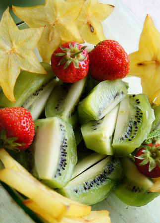 Healthy salad - mix of summer and exotic fruits             の写真素材