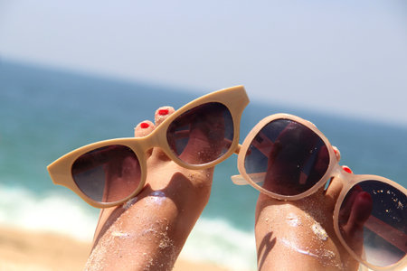 Summer holiday - funny female feet in sunglassesの写真素材