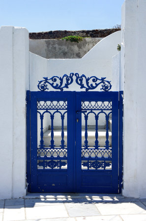 Santorini in details: blue small gate              の写真素材
