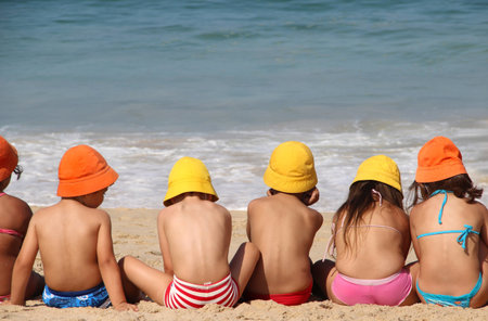 Cute children on the beach in vivid funny hats 
の写真素材