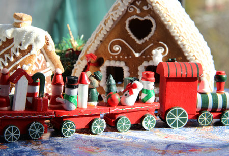 Christmas baked sweet houses and toy train with funny passengers の写真素材