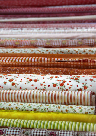 Big assortment of fabrics in the textile store 
