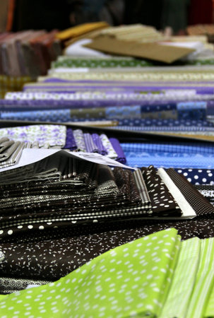 Big assortment of fabrics in the textile store 