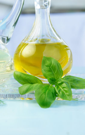 Olive oil, vinegar and basil in the beautiful crystal bottles 
の写真素材