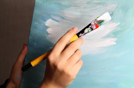 Artists hand holding a paintbrush の写真素材