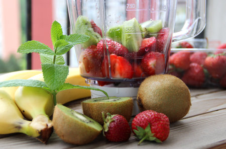 Fresh vivid smoothie ingredients and blender の写真素材