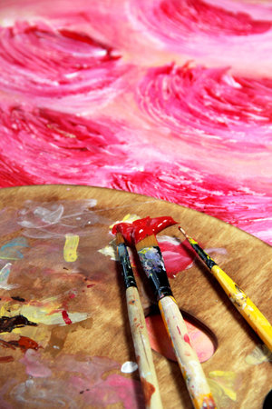 Paintbrush and beautiful painting of flowers in red and pink colorsの写真素材