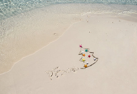 Handwriting inscription 2016 on the beach with clean blue waterの写真素材