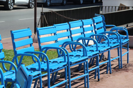 Blue chairs of Cannes and the city, French Riviera, Franceの写真素材